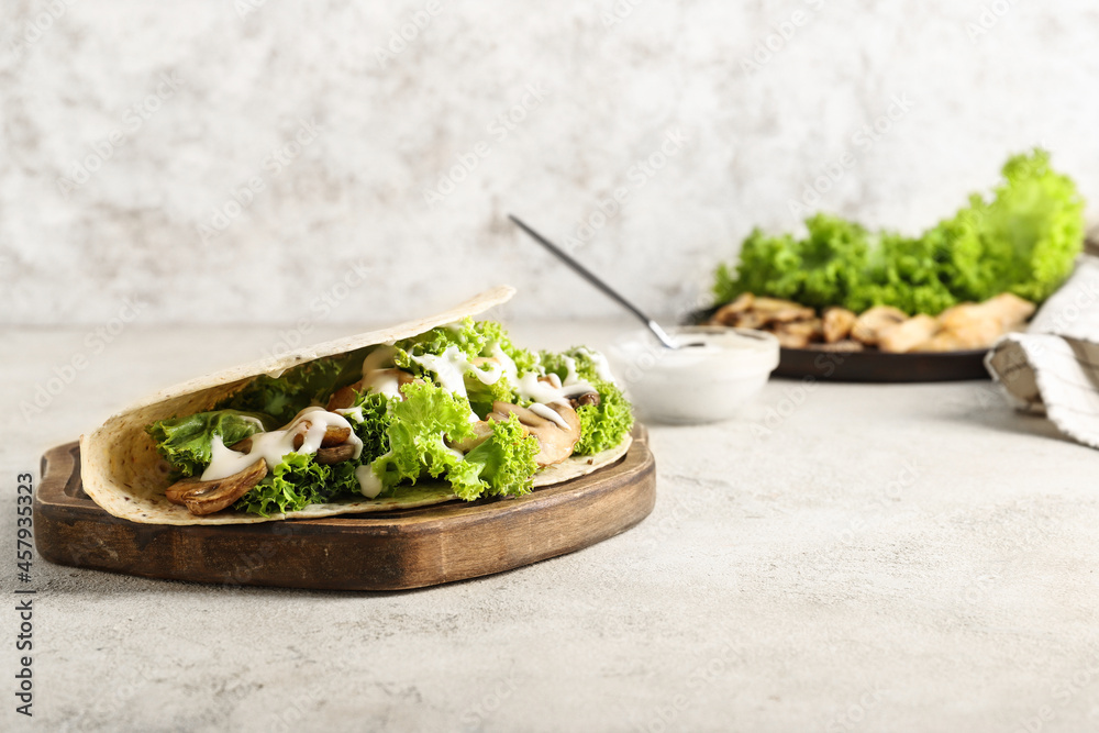 Wooden board with tasty Fajitas on light background Wooden board with tasty Fajitas on light background