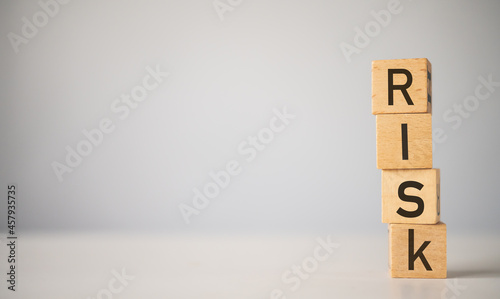wooden block with the word "RISK". Concept risk management.