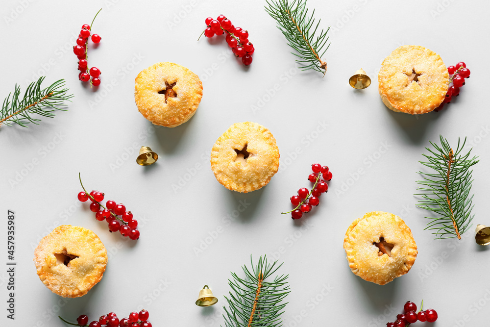 Composition with Christmas mince pies, cranberry and fir branches on white background