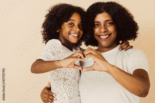 selective focus hands of mom and child making a heart. photo