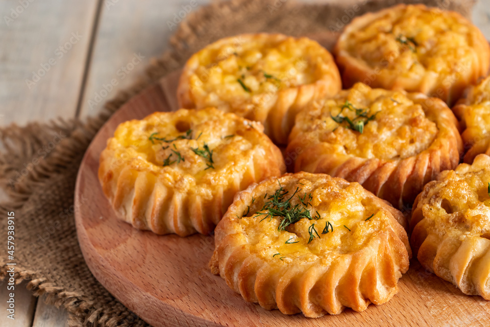Fresh muffins with vegetables and cheese on wooden board. Delicious homemade cakes for healthy diet. Recipe for autumn seasonal dish. Fresh muffins with vegetables and cheese on wooden board. Delicious homemade cakes for healthy diet. Recipe for autumn seasonal dish.
