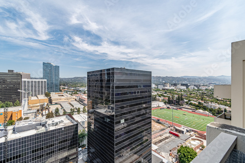 Aerial view of an urban sports park next to skyrise building.
