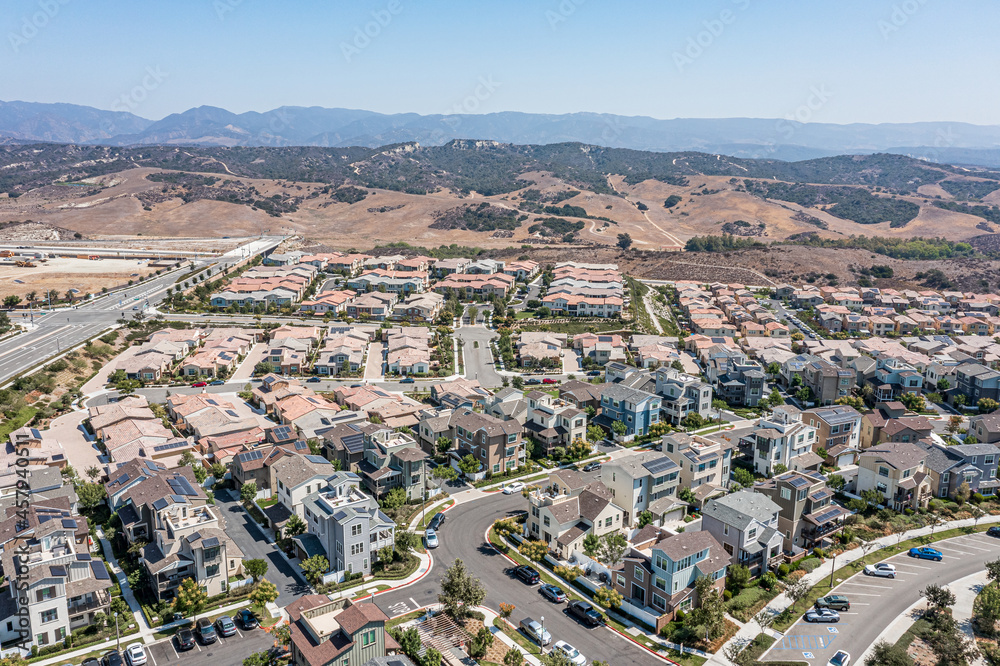 Aerial view of a modern upscale suburban neighborhood with single family homes on a clear day