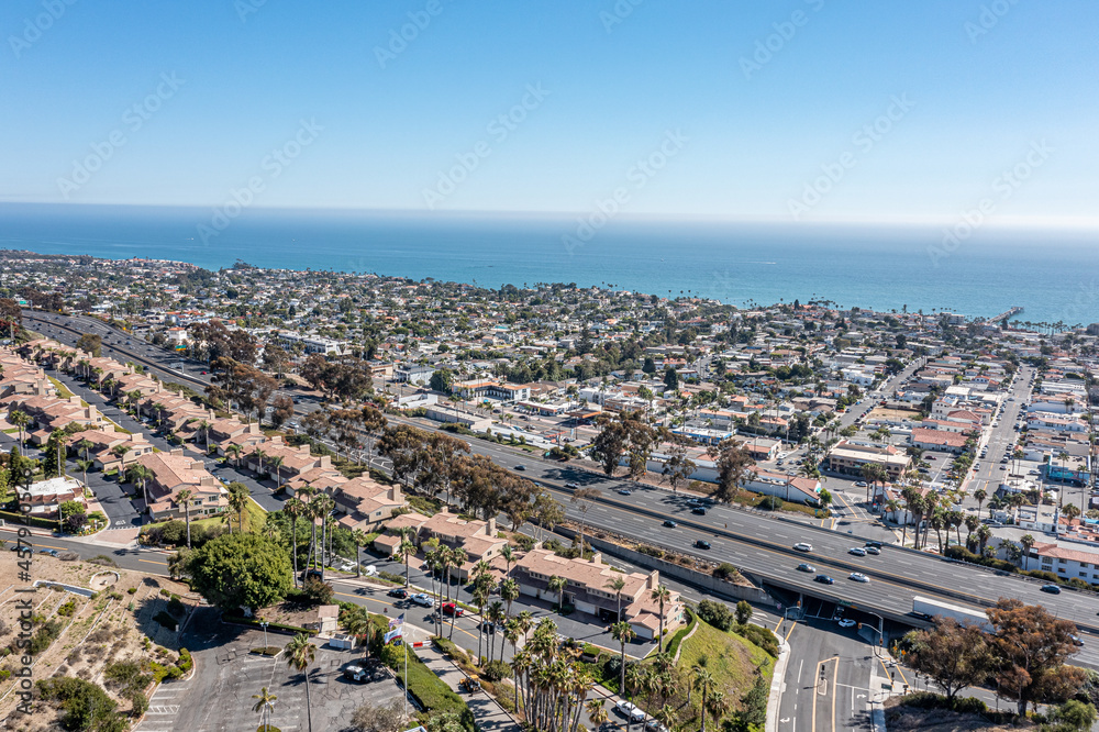 Fototapeta premium Aerial view of a coastal community, freeway, and ocean.