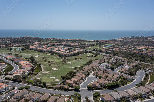 Aerial View of an upscale California oceanfront neighborhood, aerial view of golf course, ocean, and master planned community