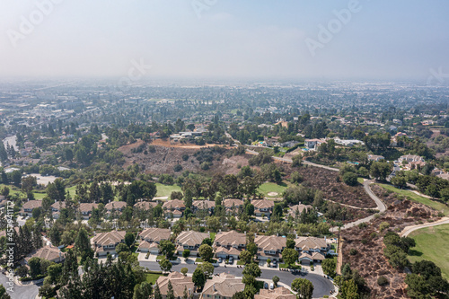 Aerial View of a Suburban California Community Near a Golf Course on a Foggy Day © Justin
