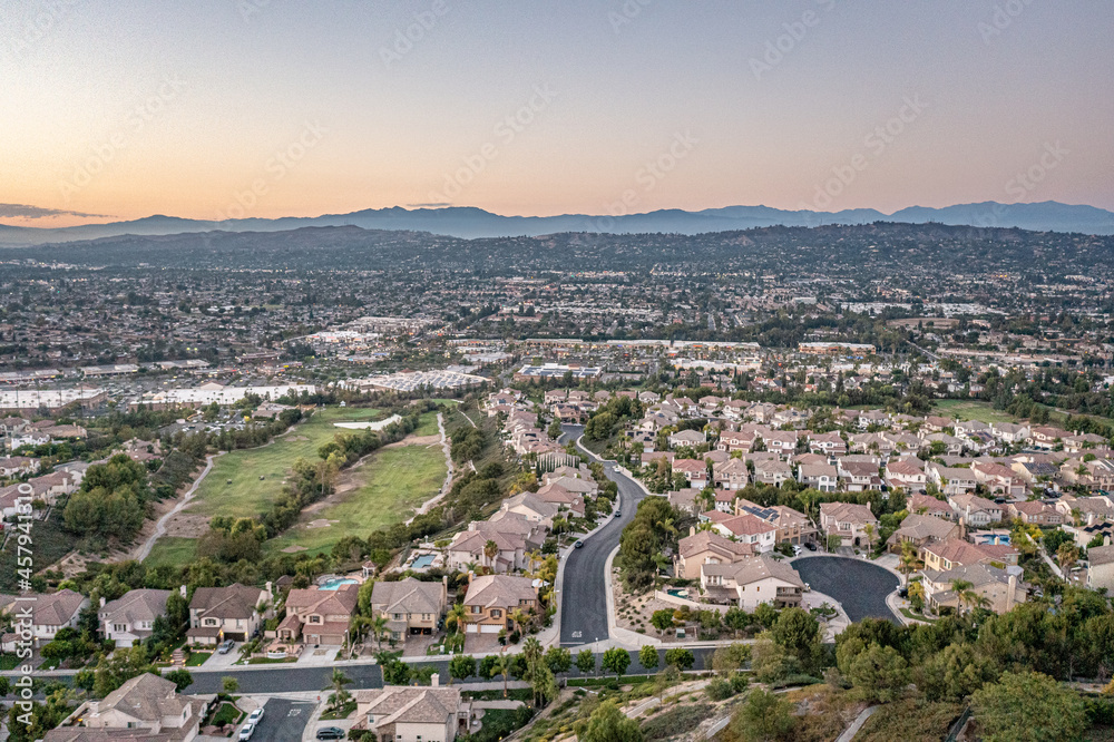 Aerial view of a gorgeous southern California sunset from an upscale neighborhood on a golf course. 