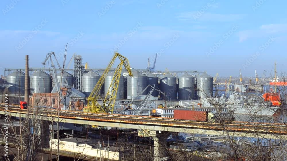 Seaport in Odessa Ukraine, with busy commercial truck traffic in Europe, crossing a bridge near an industrial port area with cranes Seaport in Odessa Ukraine, with busy commercial truck traffic in Europe, crossing a bridge near an industrial port area with cranes