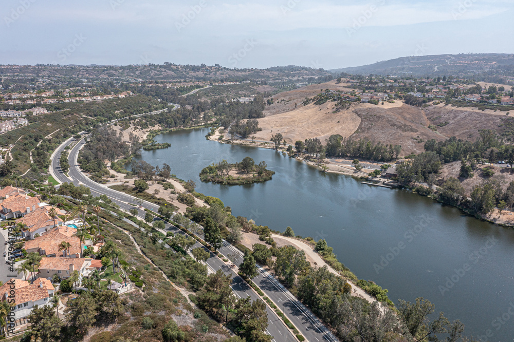 Aerial view of homes on a hill overlooking a lake in Southern California.