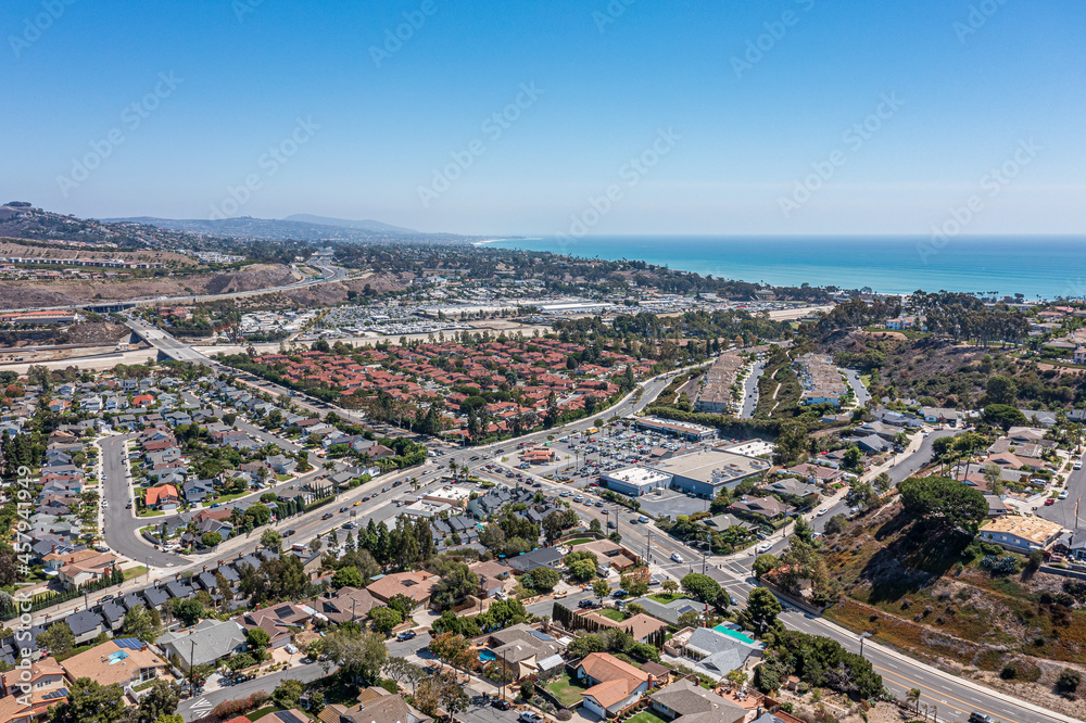 Fototapeta premium Shopping center aerial view. Southern California community near the ocean