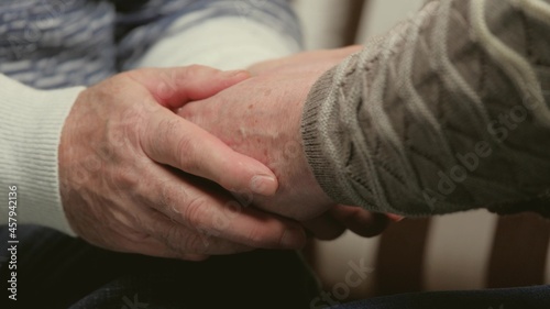 Close-up of the hands of lovely elderly couple caring and loving each other. Health care concept. Happy old couple holding hands. Beautiful family shots. Maintain trust in your marriage relationship.