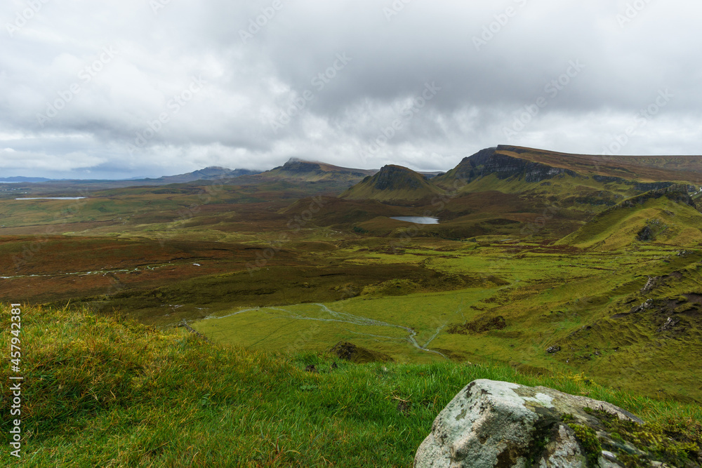 Beautiful mountain range landscape of Quiraing with green grass and lakes, Isle of Skye, Scotland