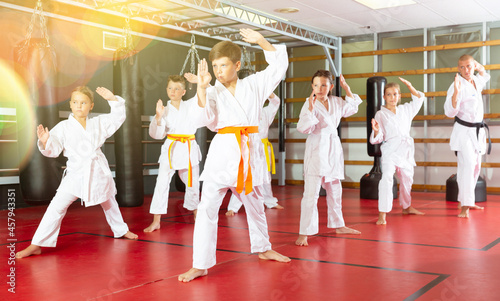 Group of kids at taekwondo workout, training attack movements