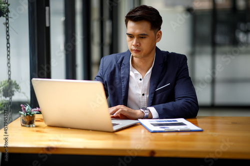 Εκτύπωση καμβά Young handsome man or businessman working on laptop computer in modern office