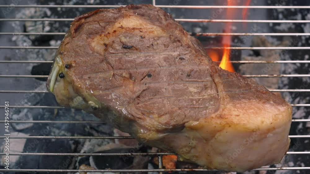 Video Stock Rib eye steak beef Grill with Butter and garlic on the