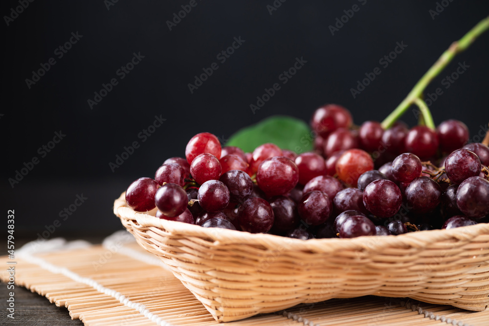 Fresh red grape in a basket with black background, Organic tropical fruit Fresh red grape in a basket with black background, Organic tropical fruit