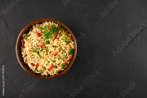 on a black background in a wooden plate noodles