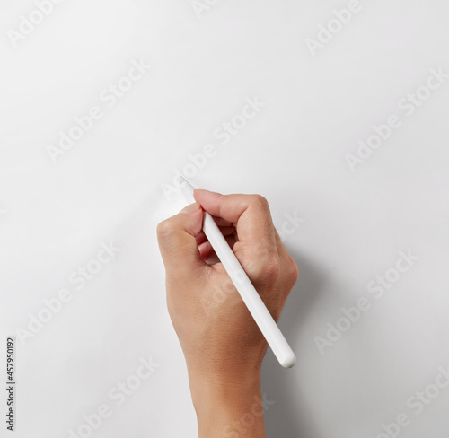 Fototapet Hand holding a white stylus pen isolated on white background