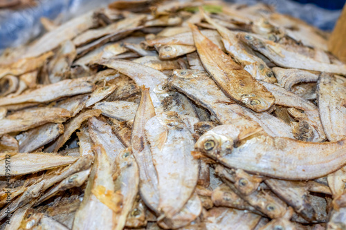 A pile of salty dried sea fish close up view on a market with selective focus
