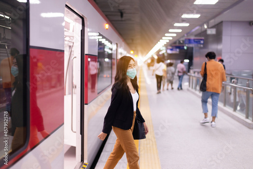 Asian women getting off a train at station,Transport and train concept