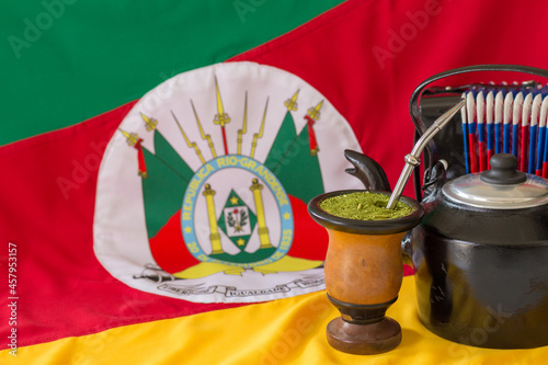 Accordion, kettle, mate and state flag of Rio Grande do Sul - Brazil in the background. Decoration in celebration of the traditional week of the south of Brazil. 