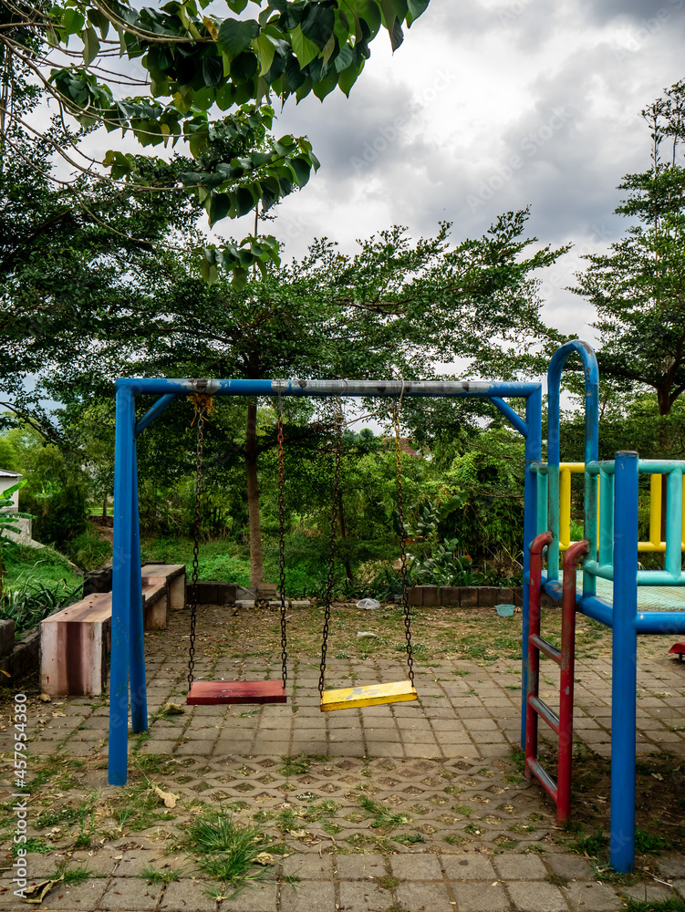 children's swing in a deserted playground due to the covid pandemic
