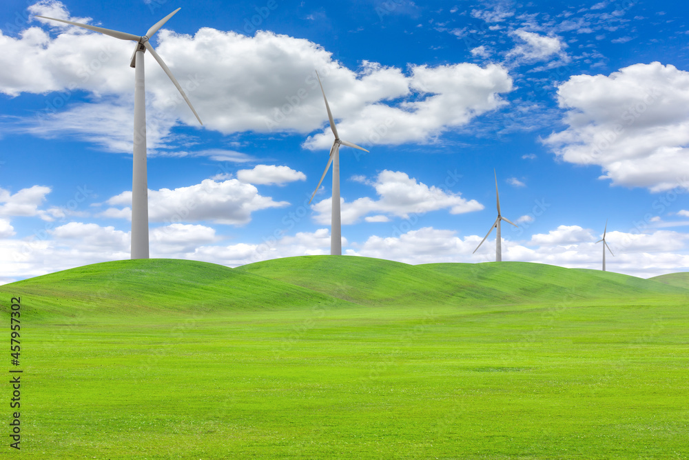 Wind turbines in a field of green grass Wind turbines in a field of green grass