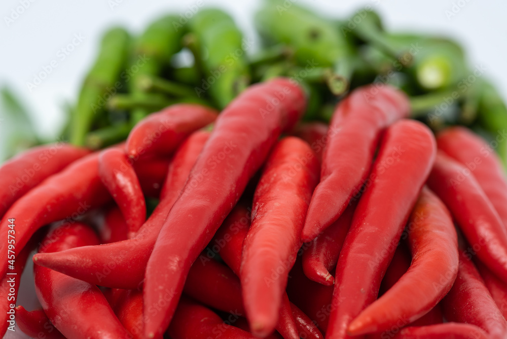 Red and green hot chili peppers isolated on white background. Red and green hot chili peppers isolated on white background.