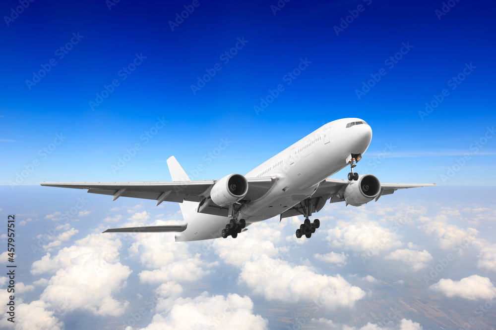 Passenger aircraft flying high above the clouds after takeoff Passenger aircraft flying high above the clouds after takeoff