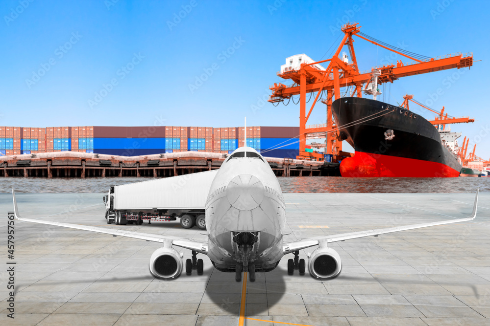 Fototapeta premium Transport air plane being unloaded container to truck commercial delivery cargo at airport with container ship at the harbor