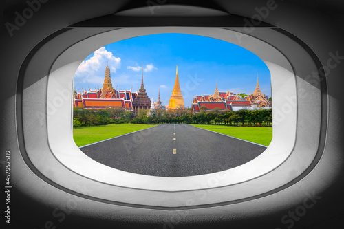 Window view of airplane with on the runway to the Grand Palace in Bangkok, Thailand.