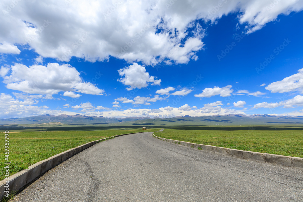Empty asphalt road on the green grassland in Xinjiang,China. Empty asphalt road on the green grassland in Xinjiang,China.