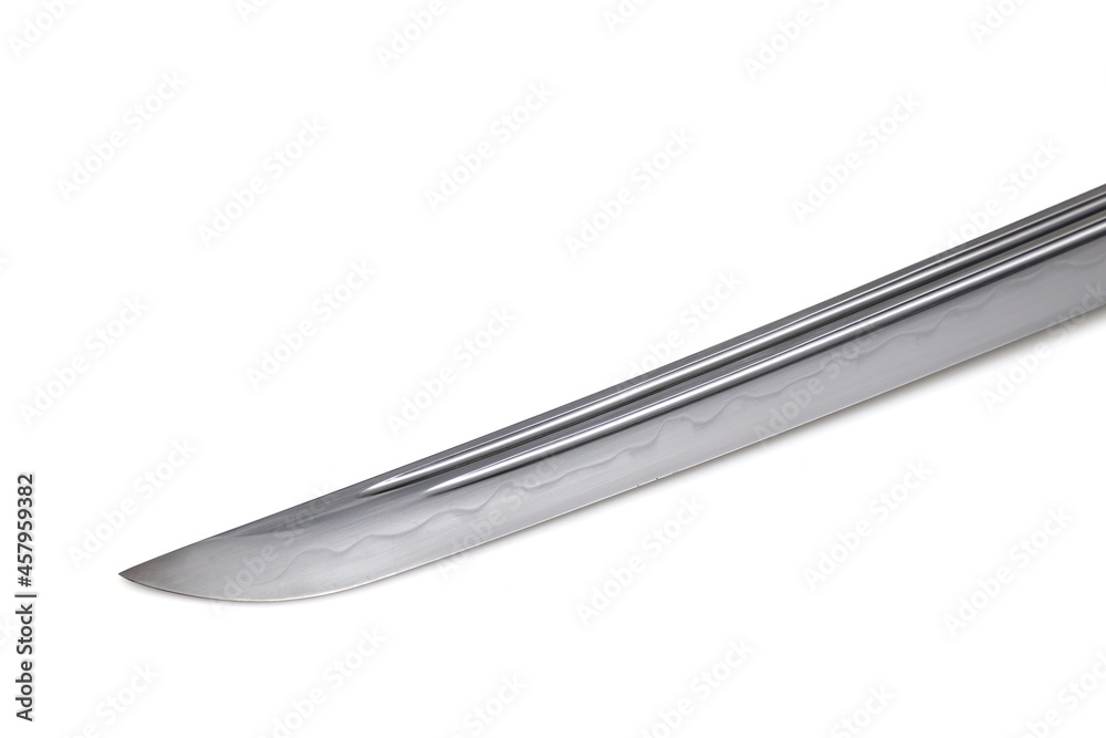 Japanese sword blade (made in China) on white background. Soft focus. The wavy pattern on the blade edge is a line of hardness that a blacksmith makes so that the blade doesn't break. Japanese sword blade (made in China) on white background. Soft focus. The wavy pattern on the blade edge is a line of hardness that a blacksmith makes so that the blade doesn't break.