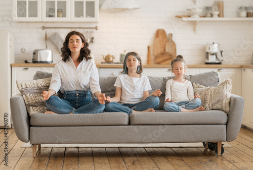 Woman and children are meditating