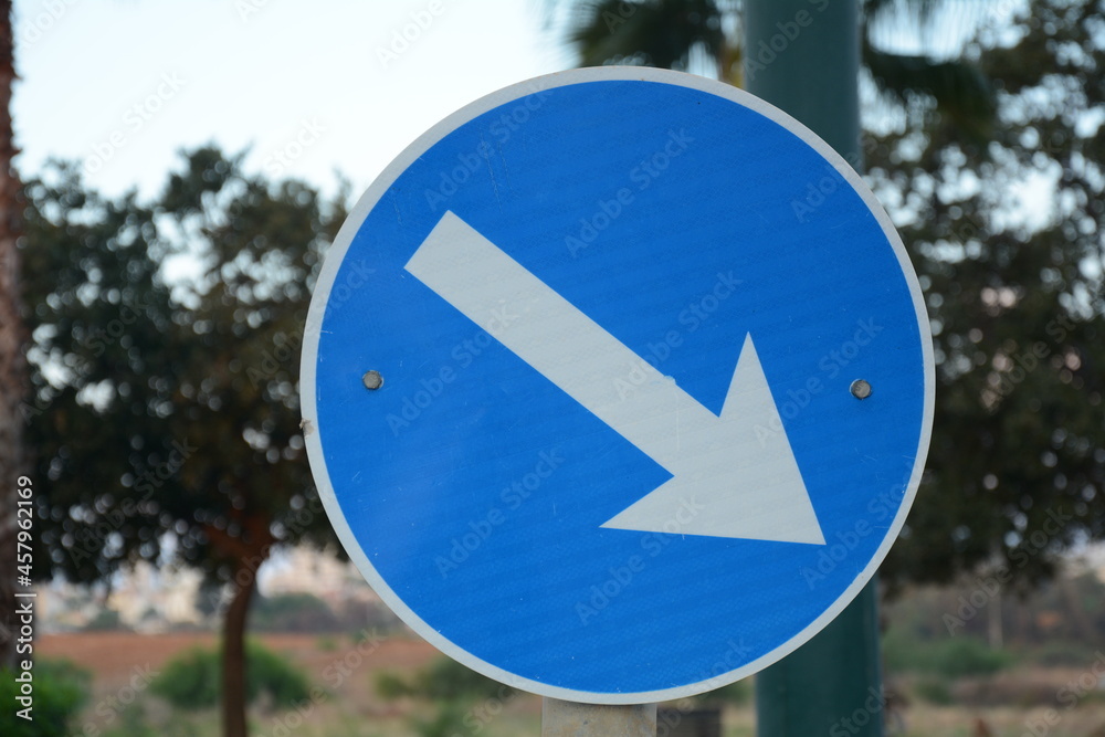 Pass designated place on right. Blue road sign Pass on This Side with white arrow pointing to the right. Mandatory signs. Road signs in Israel