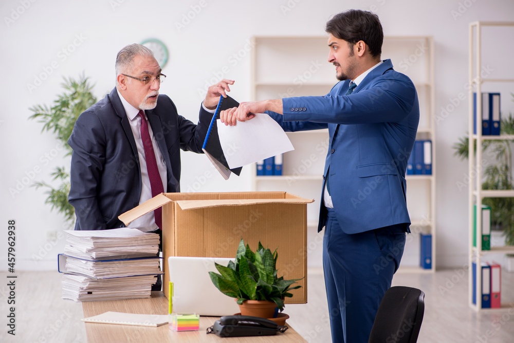 Two male employees in dismissal concept Two male employees in dismissal concept