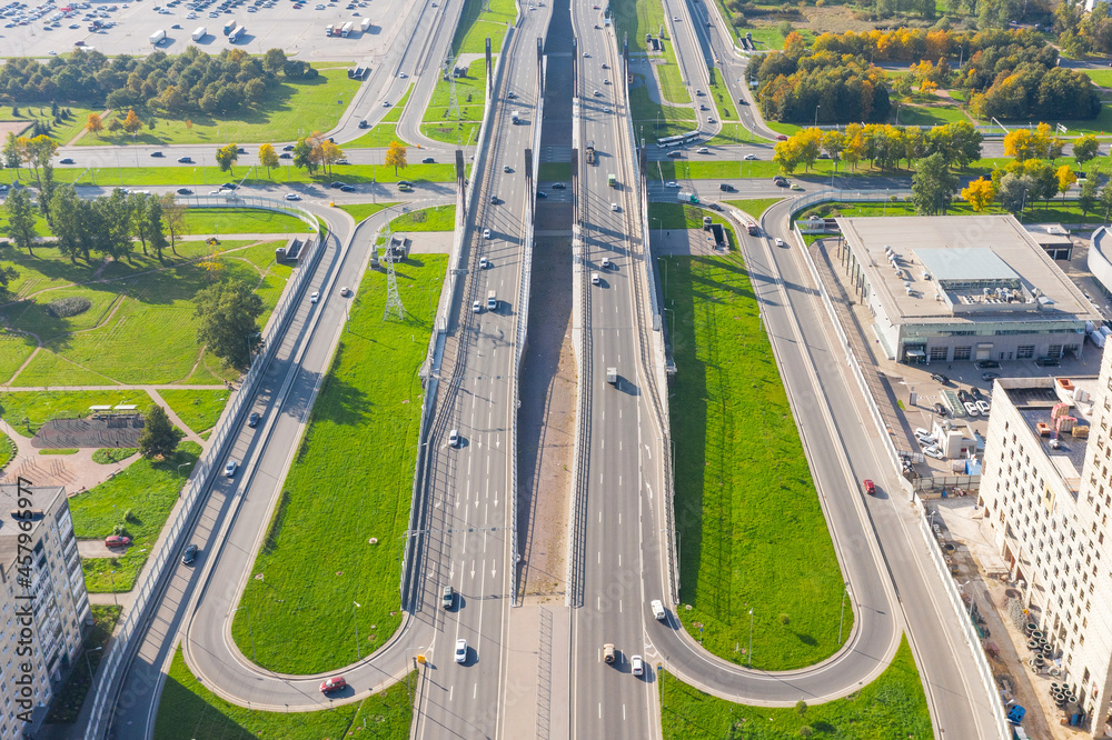 Aerial view of the intersections of the city highway. Vehicles driving on the roads.