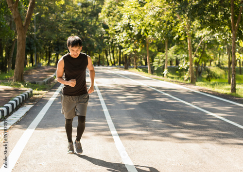 Asian men exercising running in the park for health