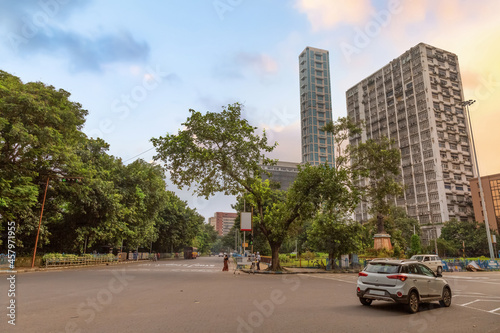 Indian city road with high rise commercial buildings and early mooning city traffic at Kolkata India  © Roop Dey