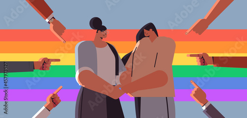 unhappy lesbian couple surrounded by hands fingers mocking discrimination transgender love LGBT community