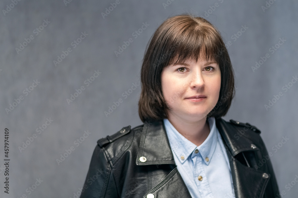 Portrait of young confident woman, bob haircut in leather jacket. Brunette girl with round face shape. Middle aged woman Portrait of young confident woman, bob haircut in leather jacket. Brunette girl with round face shape. Middle aged woman