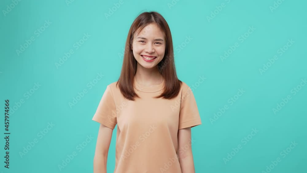 Beautiful Asian woman hand hold making movie production clapperboard on the blue background.