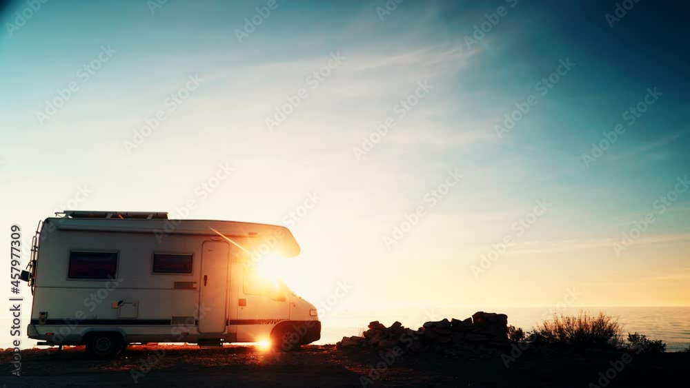 Camper vehicle camping on coast sea shore at sunrise. Adventure, travel with motor home. Camper vehicle camping on coast sea shore at sunrise. Adventure, travel with motor home.