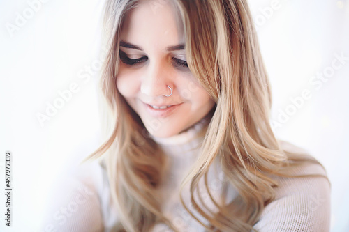 girl portrait piercing nose / model blonde young posing with a ring in her nose, girl hipster