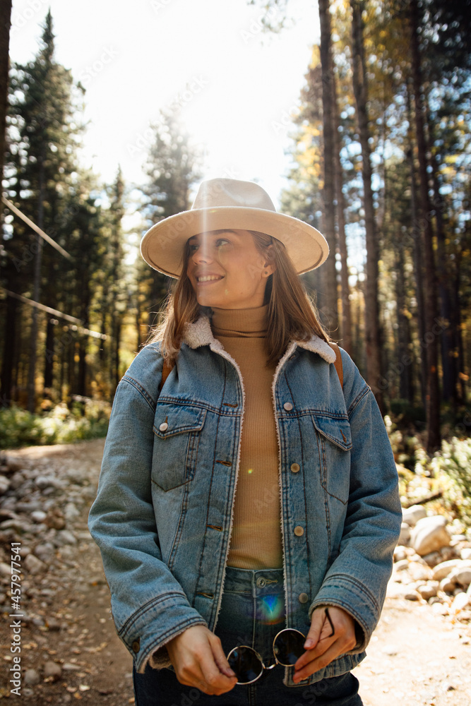 A girl in a hat at the autumn forest