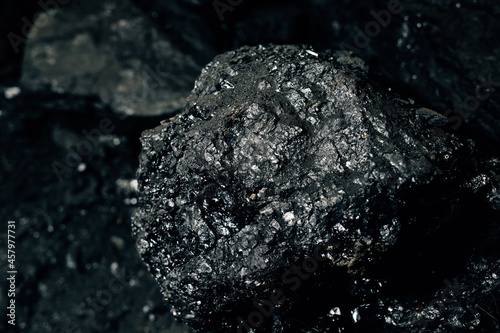 Black coal stones close-up. Solid advertising background. Mining for heating.