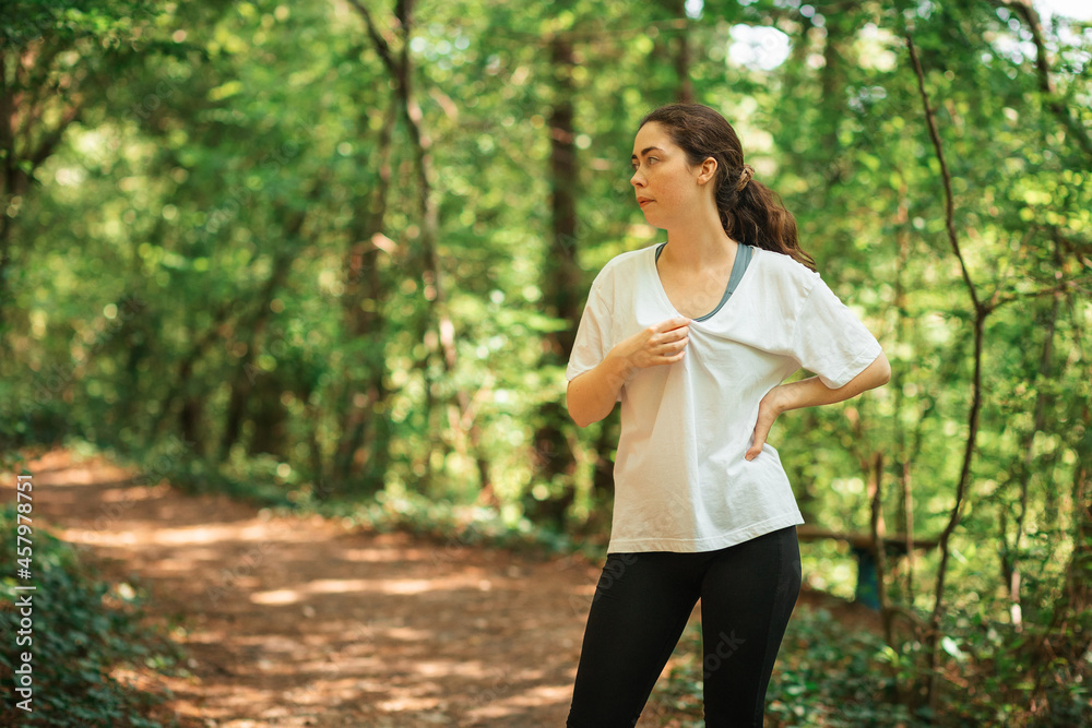 Wellness. Portrait of tired woman relax after training at summer forest. The concept of cross-country running Wellness. Portrait of tired woman relax after training at summer forest. The concept of cross-country running