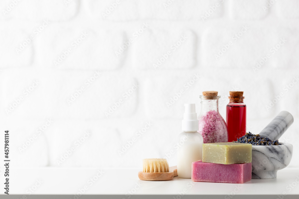 Cosmetics bottles and natural handmade soap on white background Cosmetics bottles and natural handmade soap on white background
