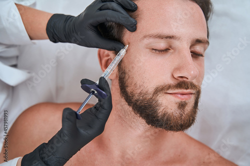 eauty salon customer getting a dermal filler injection photo