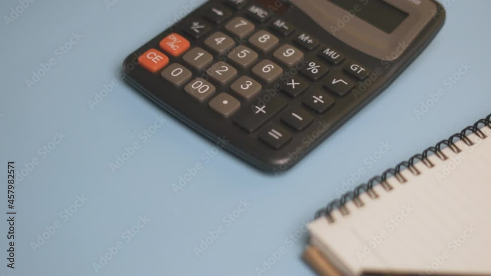 Calculator and notepad on desk. Working space. Close-up view of accountant work desktop Calculator and notepad on desk. Working space. Close-up view of accountant work desktop